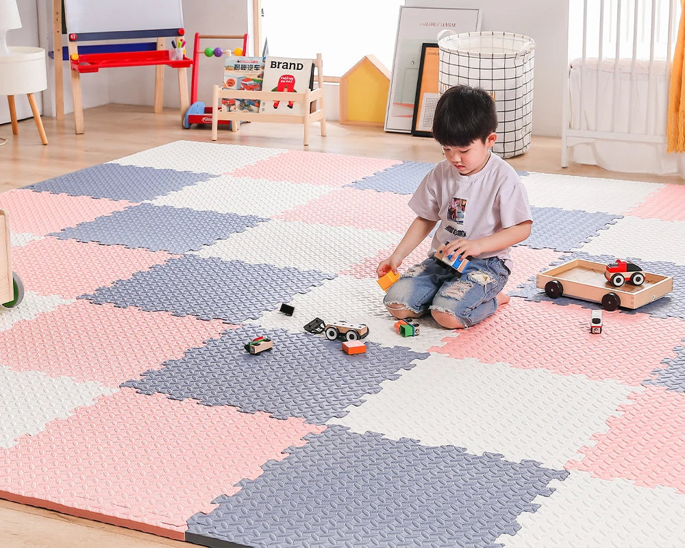 toddler playing on an assembled playmat tiles